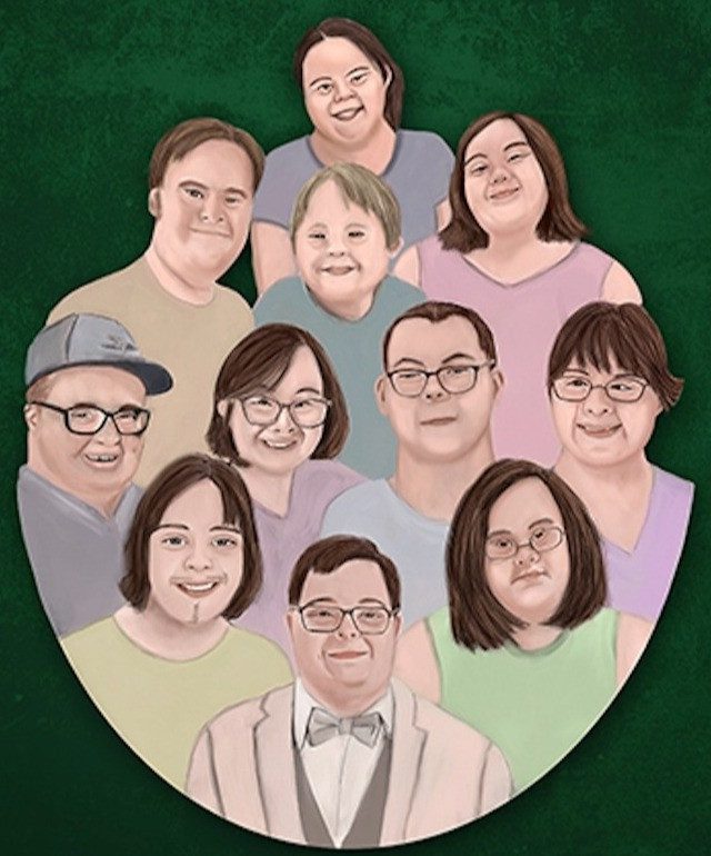 A group of 11 smiling people with Down syndrome, of various ages and genders, are arranged in a circle.