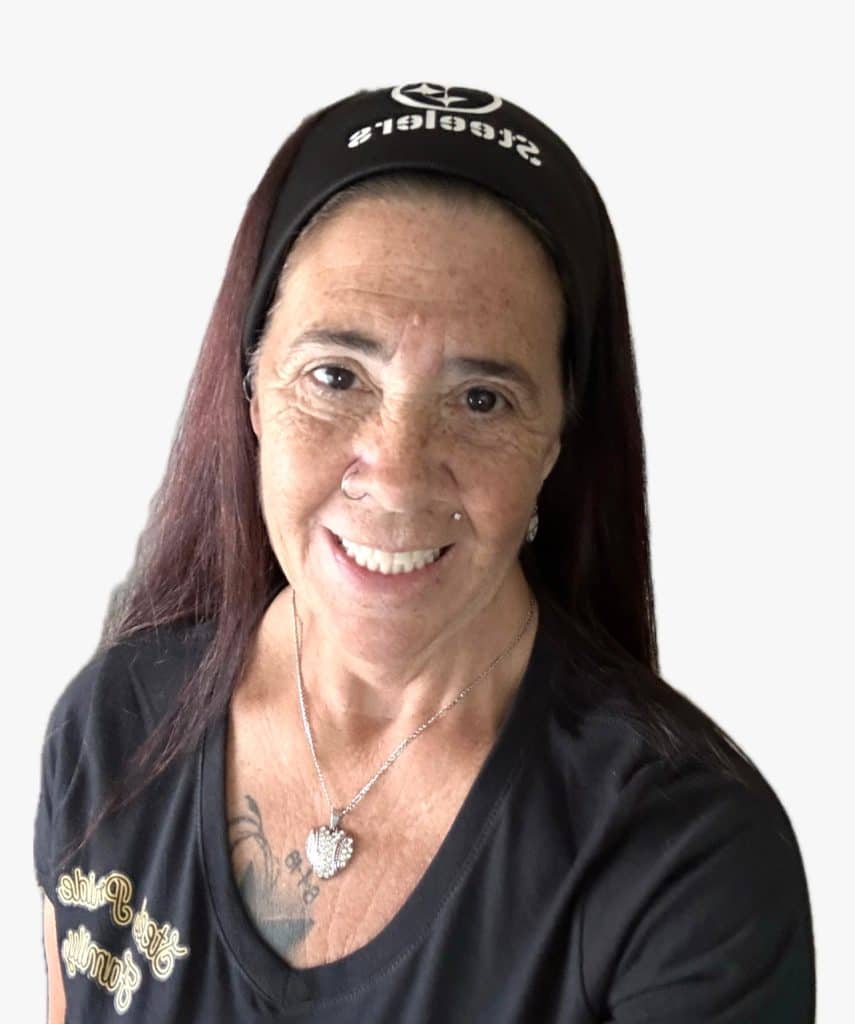 A smiling woman with long brown hair wears a black headband with "Steelers" and a black t-shirt.